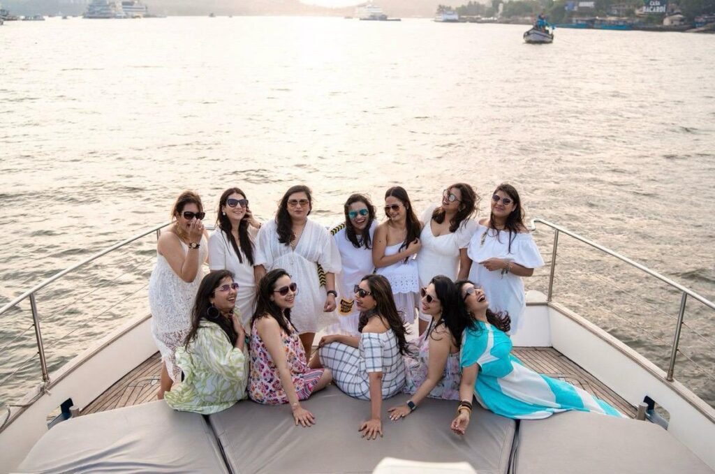 Group of women celebrating on a luxurious yacht in Goa.