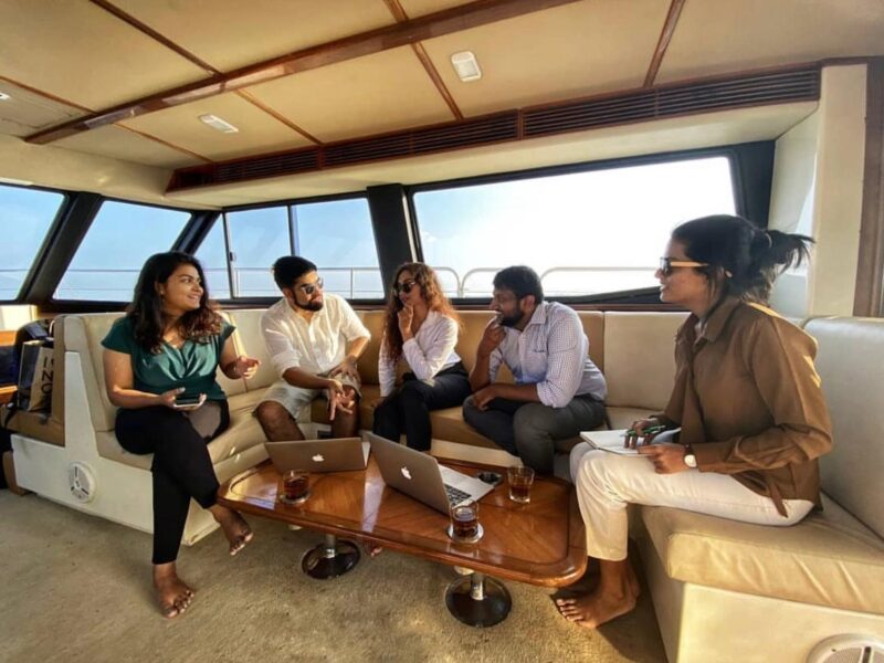 A panoramic view of Mumbai's coastline from a luxurious yacht hosting a corporate event.